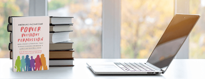 Curated stack of books and notes in a modern reading space, symbolizing learning and confidence for overcoming imposter syndrome