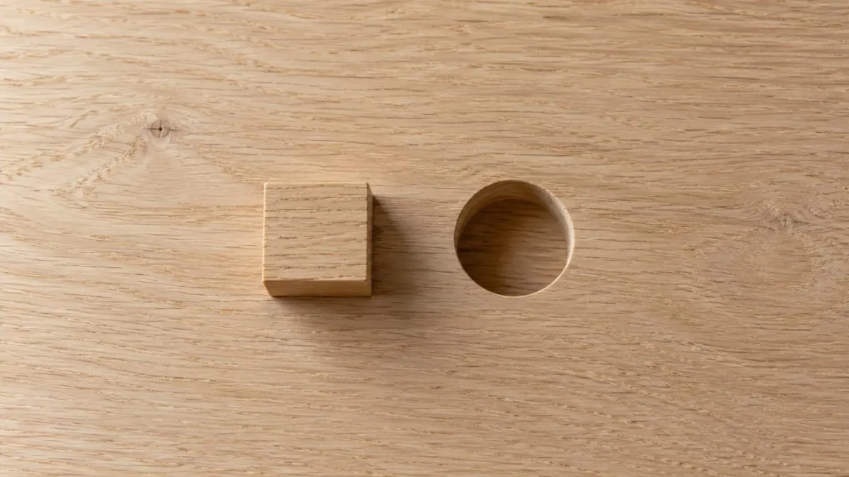 An empty chair pushed back from a meeting table with a single closed notebook in front of it, illustrating when not to hire a fractional executive